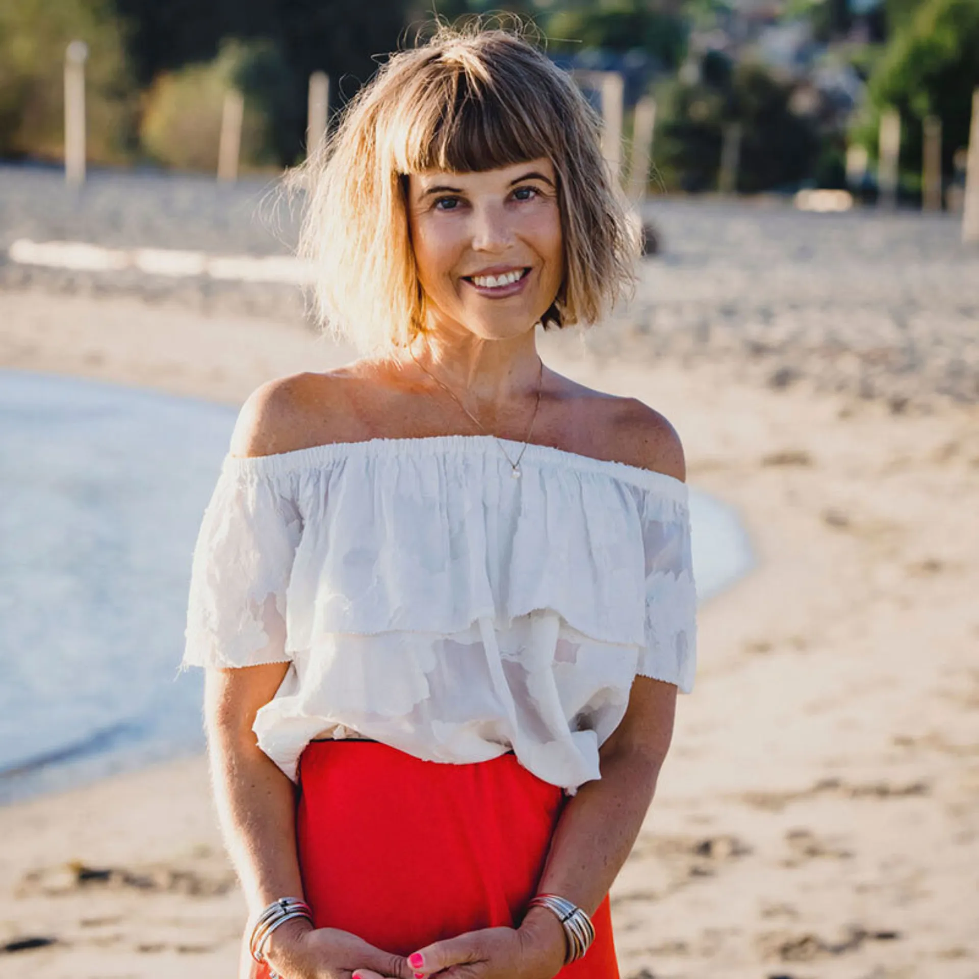 Erica standing red dress beach 800x800